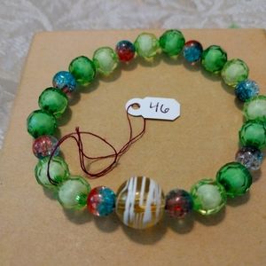Artemis's Gems custom-made beaded bracelet with large glass swirl bead, green